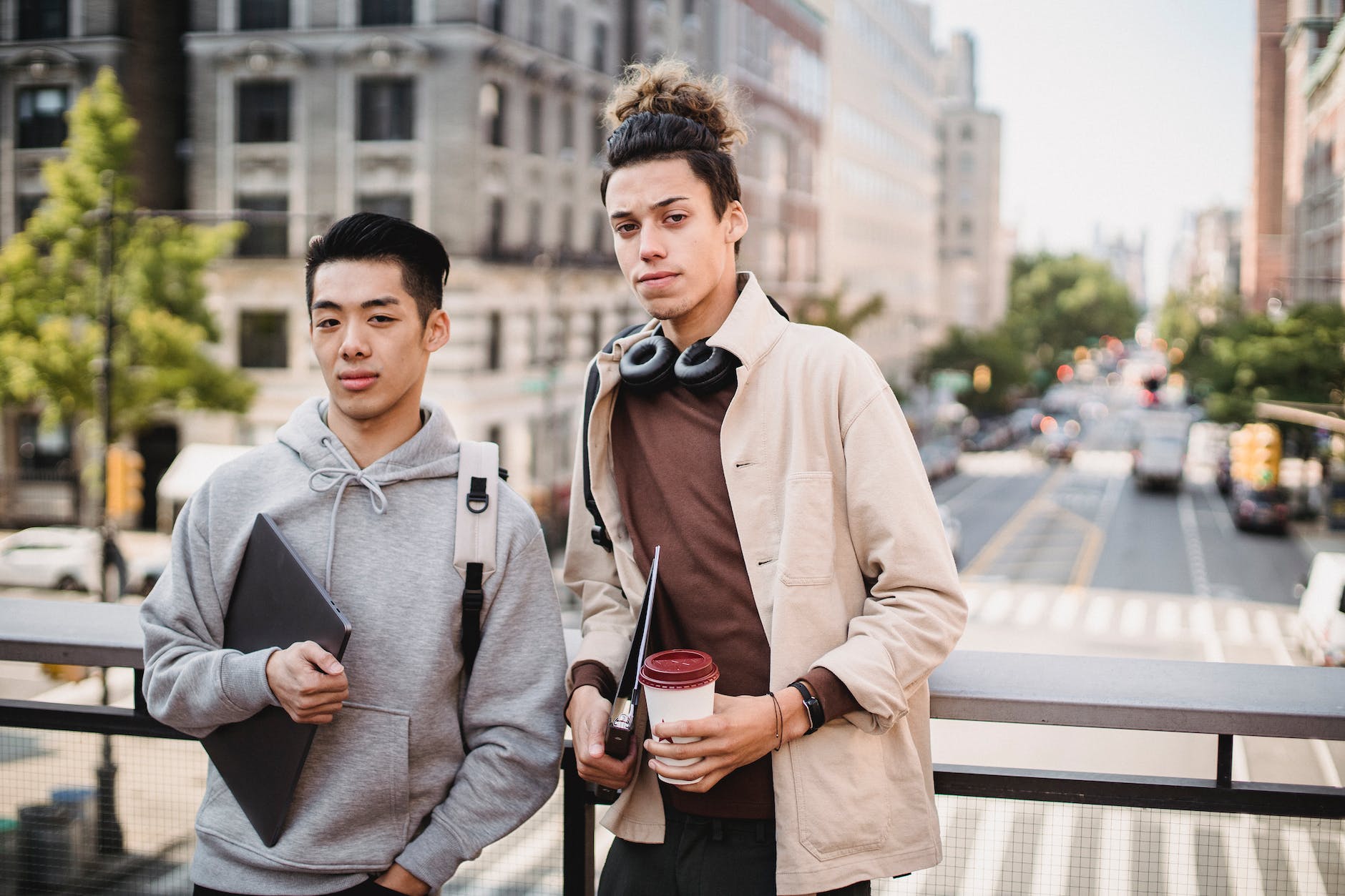 positive diverse men standing on sunny street